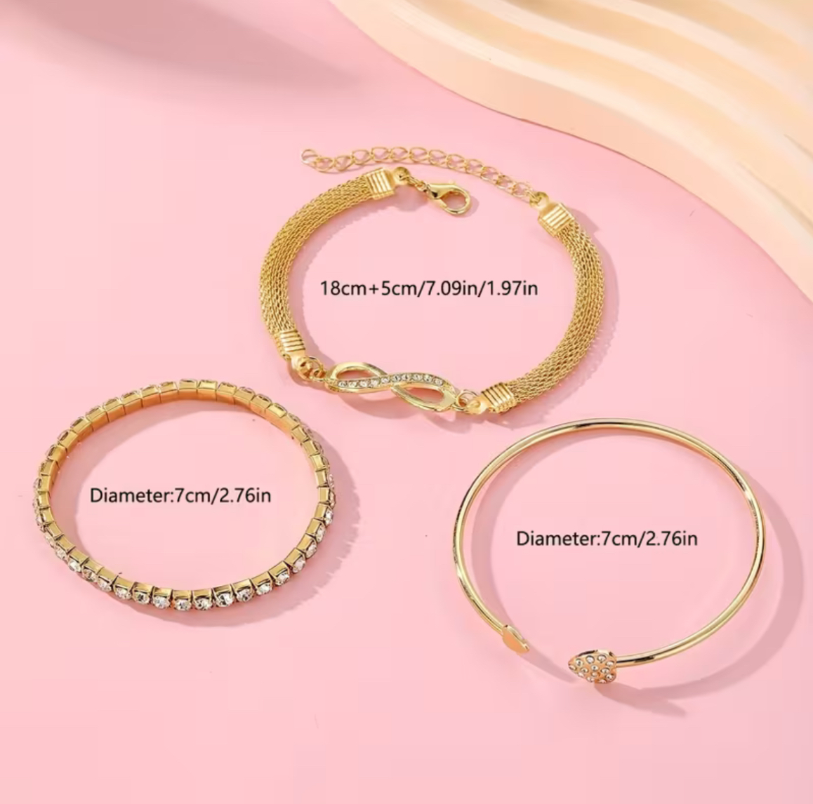 A Set of Three Women'S Bracelets And Bangles Featuring Wireless Symbols And Heart Designs Adorned with Rhinestones.